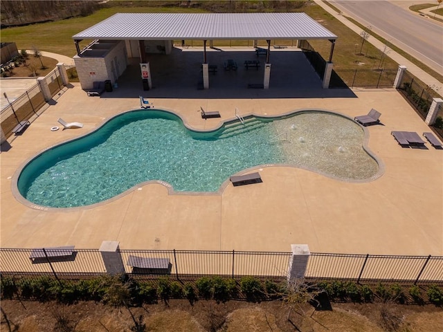 community pool featuring fence and a patio area