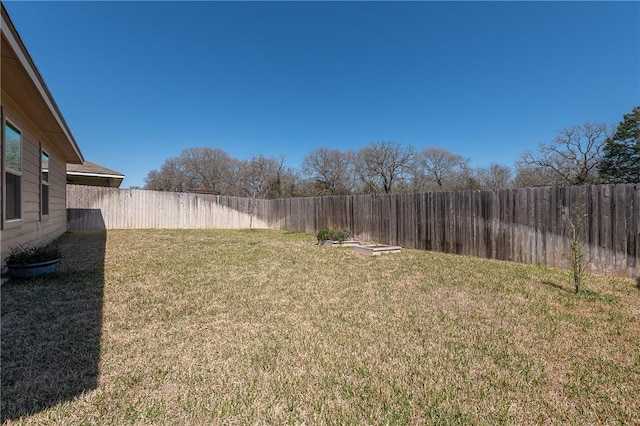 view of yard with a fenced backyard