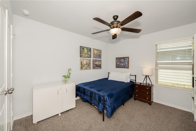 carpeted bedroom featuring ceiling fan and baseboards