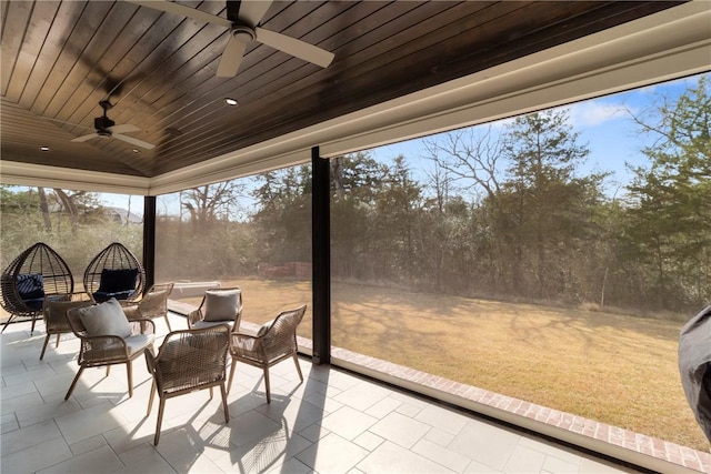 sunroom featuring vaulted ceiling, wooden ceiling, and ceiling fan