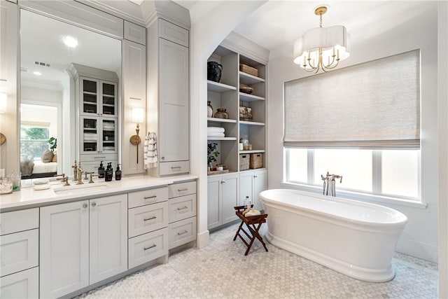 bathroom with a soaking tub, visible vents, a notable chandelier, and vanity