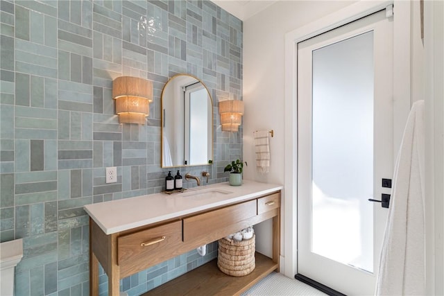 bathroom with tasteful backsplash, vanity, and tile walls