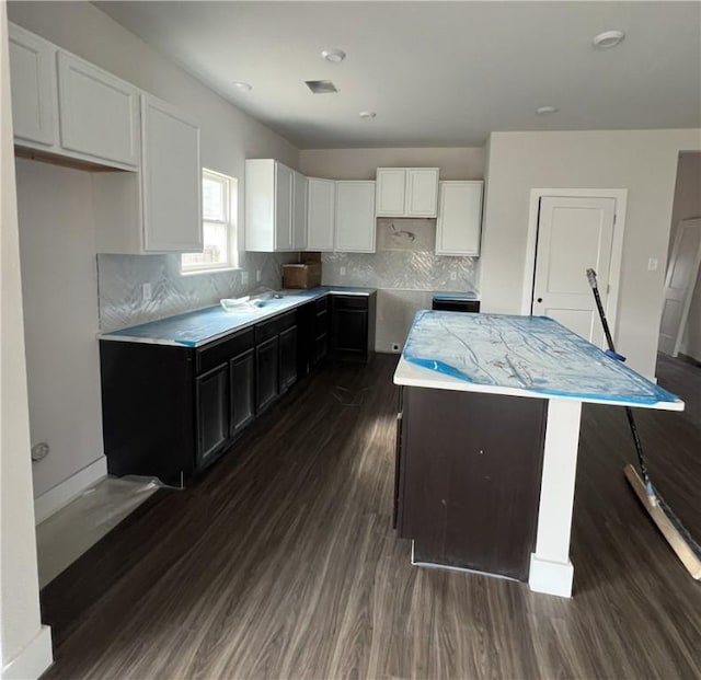 5324 Lyle Pl, Bryan, TX 77807 - kitchen featuring dark wood-style flooring, white cabinets, backsplash, a center island, and light countertops