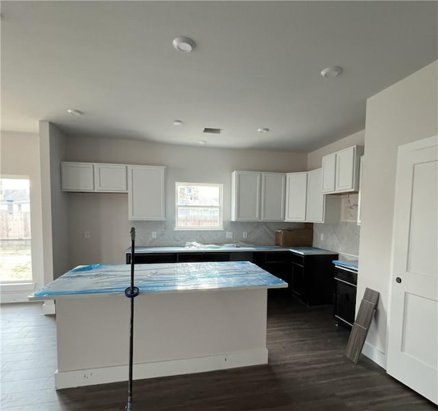 5324 Lyle Pl, Bryan, TX 77807 - kitchen with a kitchen island, tasteful backsplash, dark wood finished floors, white cabinets, and recessed lighting
