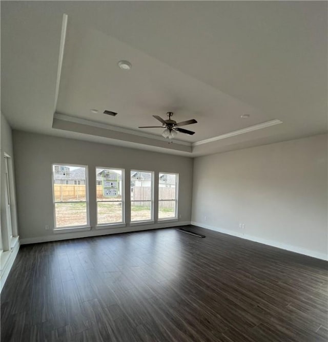 5324 Lyle Pl, Bryan, TX 77807 - unfurnished room with a raised ceiling, ceiling fan, dark wood finished floors, and crown molding