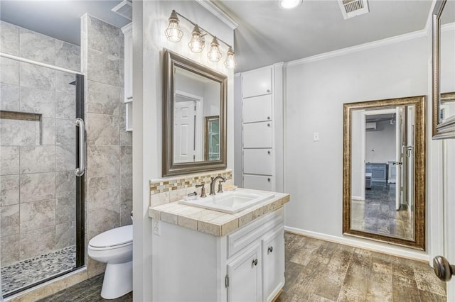 bathroom with walk in shower, vanity, wood-type flooring, and toilet