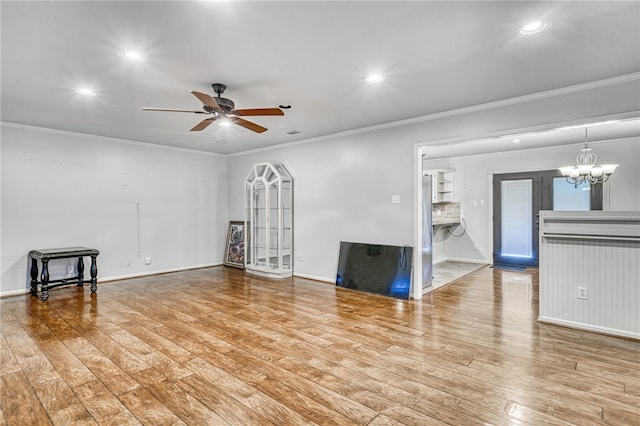 unfurnished living room with crown molding, light hardwood / wood-style floors, and ceiling fan with notable chandelier