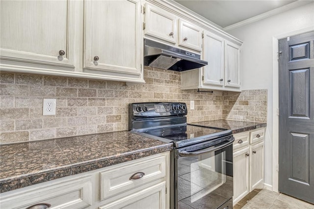 kitchen with electric range, decorative backsplash, dark stone countertops, ornamental molding, and light tile patterned floors