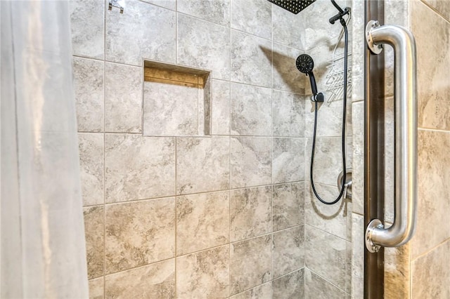 interior details with a tile shower