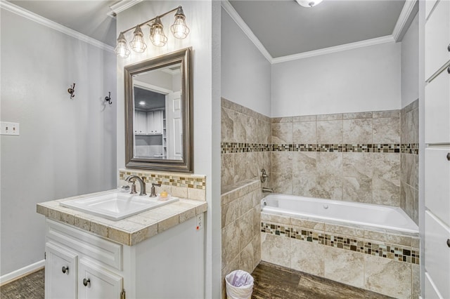 bathroom featuring vanity, ornamental molding, and tiled tub