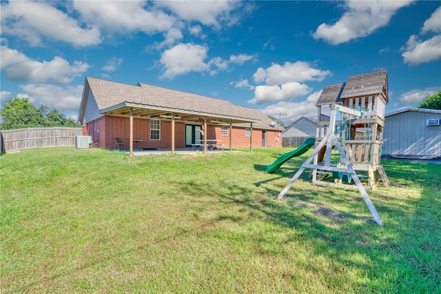 exterior space with a playground, central AC, a patio area, and a lawn