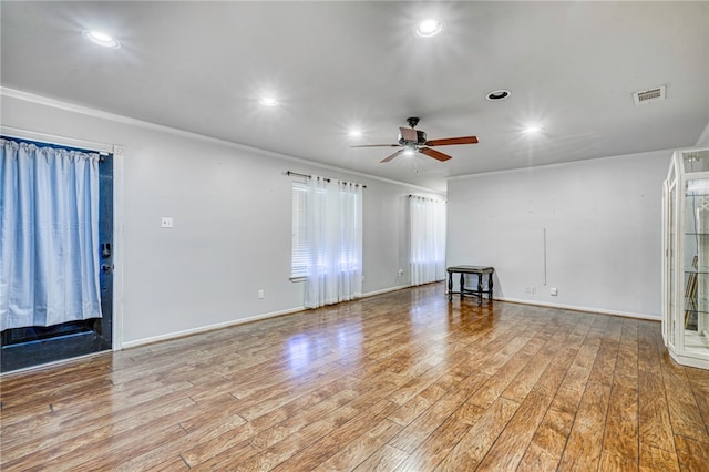 unfurnished room featuring ceiling fan, ornamental molding, and light hardwood / wood-style flooring