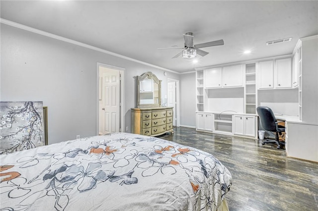 bedroom featuring ceiling fan, crown molding, built in desk, and dark hardwood / wood-style floors