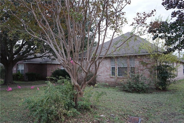 view of side of home featuring a lawn