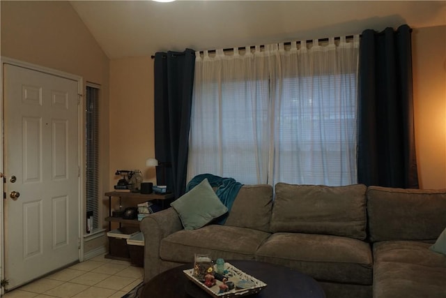 living room featuring light tile patterned floors and lofted ceiling