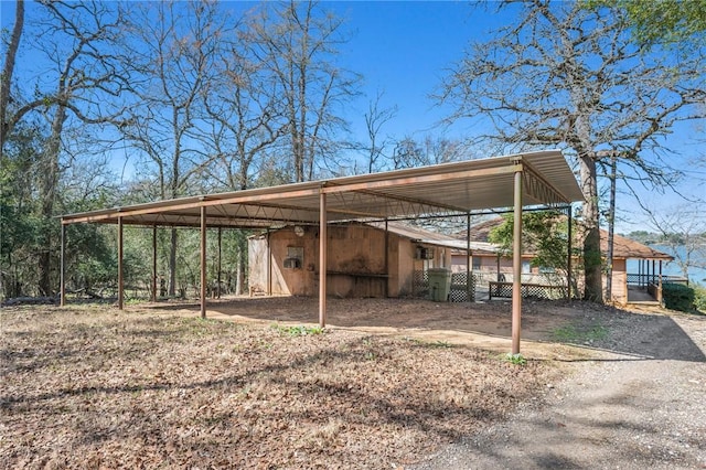 view of car parking featuring driveway and a detached carport