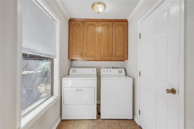 laundry room featuring cabinet space, light tile patterned floors, and washer and dryer