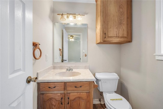 half bath featuring vanity and toilet