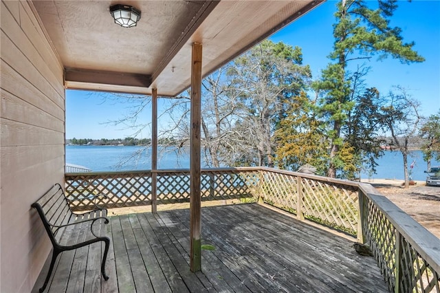 wooden terrace featuring a water view