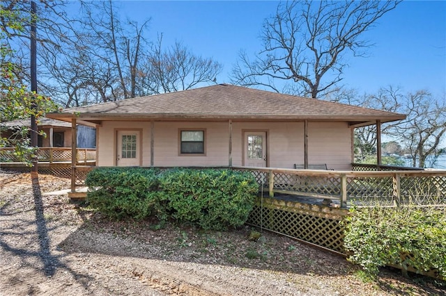 view of front of property with a shingled roof and a deck