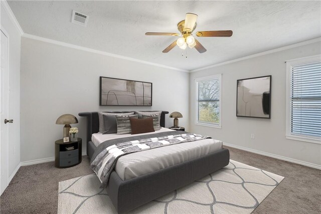 bedroom featuring ornamental molding, carpet, visible vents, and baseboards