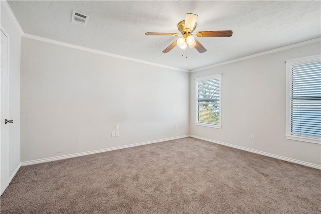 unfurnished room featuring visible vents, crown molding, and carpet flooring