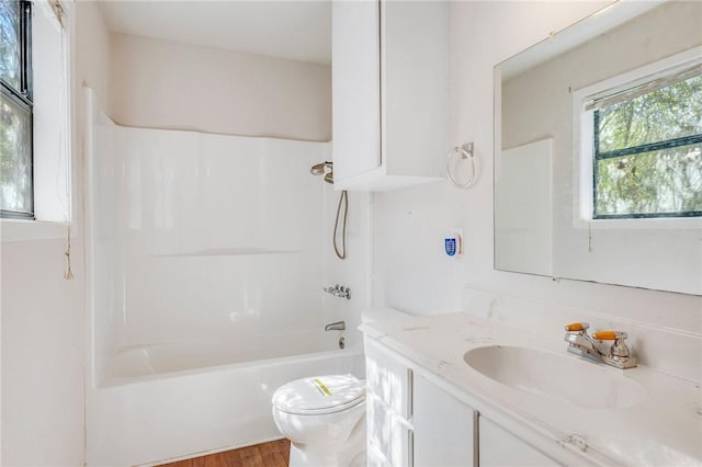 bathroom with shower / bath combination, vanity, toilet, and wood finished floors