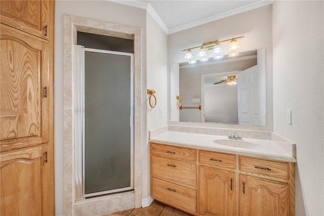 full bathroom featuring ceiling fan, tile patterned flooring, vanity, ornamental molding, and a stall shower