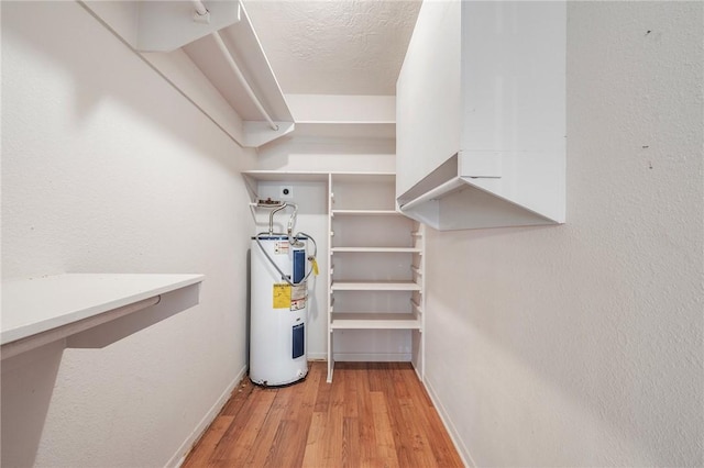 utility room featuring electric water heater