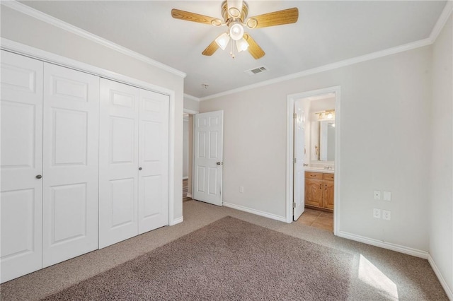 unfurnished bedroom featuring a closet, visible vents, ornamental molding, light carpet, and baseboards