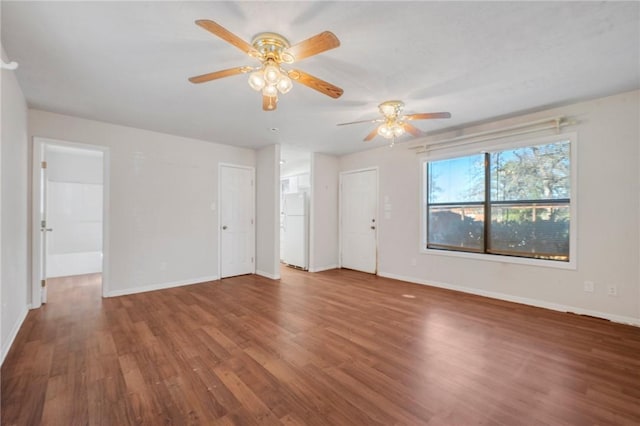 empty room featuring baseboards and wood finished floors