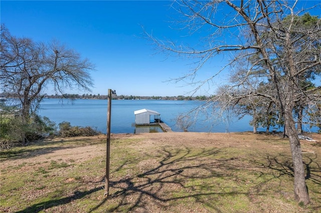 view of yard featuring a dock and a water view