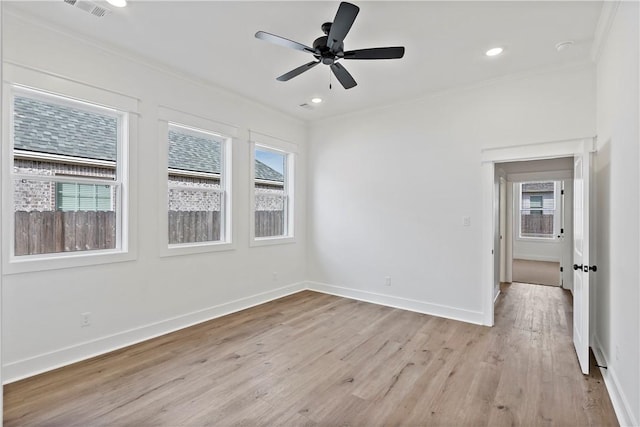 unfurnished room with ornamental molding, ceiling fan, and light wood-type flooring