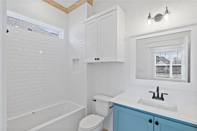 full bathroom with tiled shower / bath, a healthy amount of sunlight, toilet, and vanity