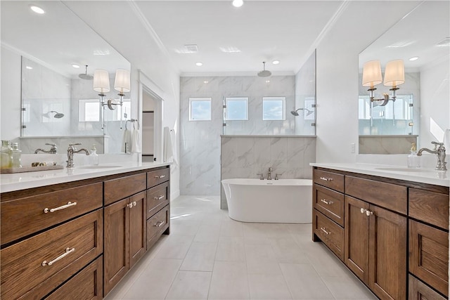 bathroom featuring independent shower and bath, ornamental molding, and a healthy amount of sunlight