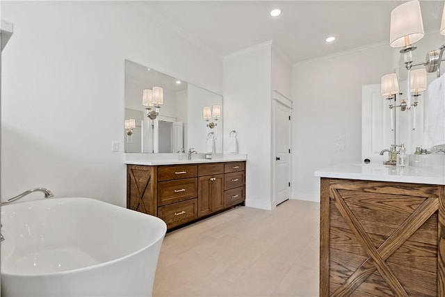 bathroom featuring ornamental molding, a tub, and vanity