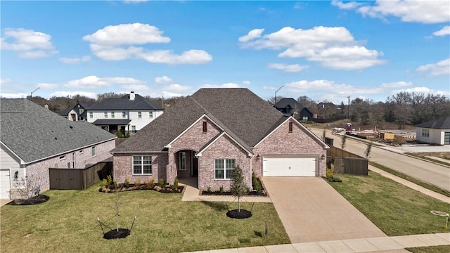 view of front of house featuring a garage and a front yard