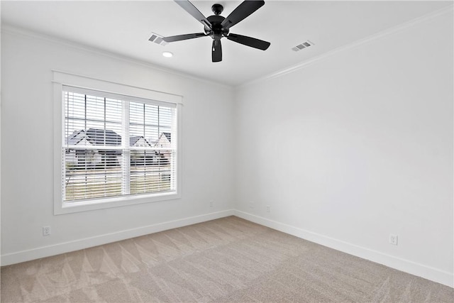 carpeted spare room with crown molding and plenty of natural light