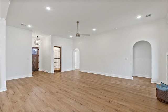 empty room featuring crown molding, light hardwood / wood-style flooring, and ceiling fan