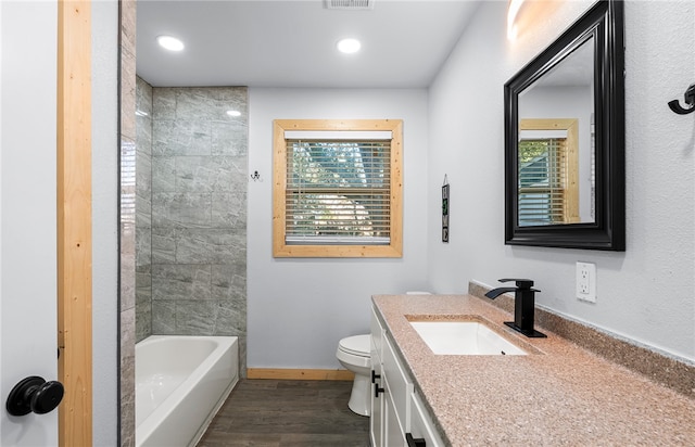 bathroom with hardwood / wood-style floors, vanity, and toilet