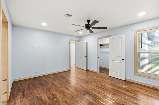 unfurnished bedroom with ceiling fan, a closet, and hardwood / wood-style flooring