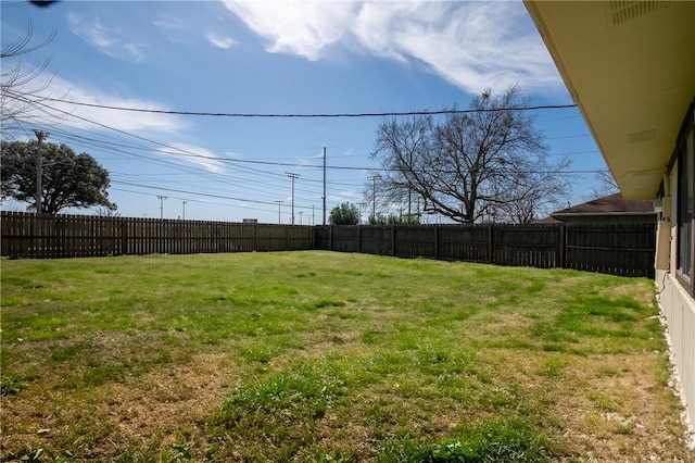 view of yard with a fenced backyard and visible vents