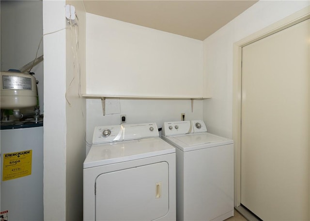 laundry room featuring laundry area, water heater, and independent washer and dryer