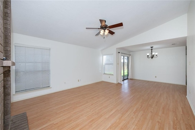 unfurnished living room featuring lofted ceiling, baseboards, light wood finished floors, and ceiling fan with notable chandelier