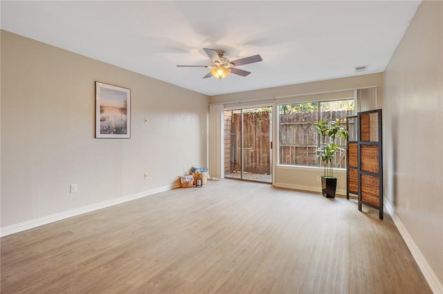 empty room featuring hardwood / wood-style floors and ceiling fan