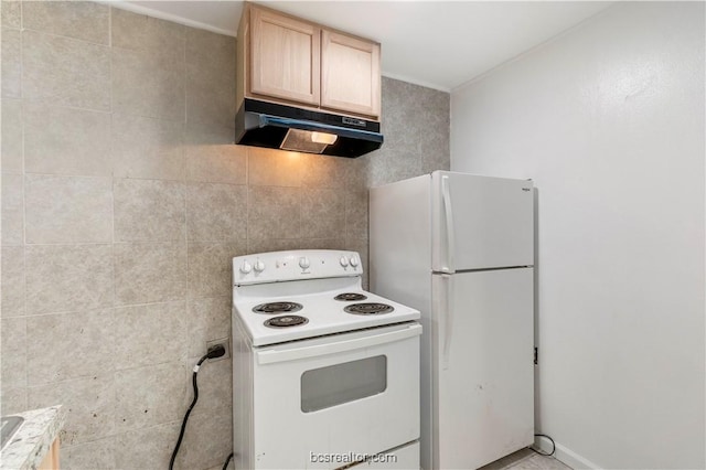 kitchen with tile walls, light brown cabinets, and white appliances