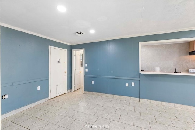 tiled empty room featuring ornamental molding