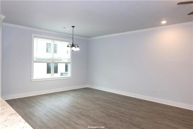 unfurnished room featuring dark hardwood / wood-style flooring, ornamental molding, and a notable chandelier