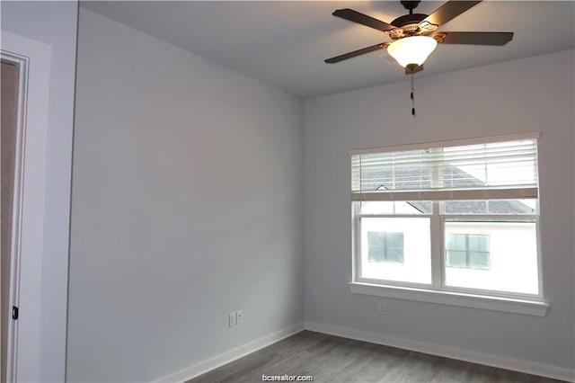 empty room featuring hardwood / wood-style flooring, ceiling fan, and a healthy amount of sunlight