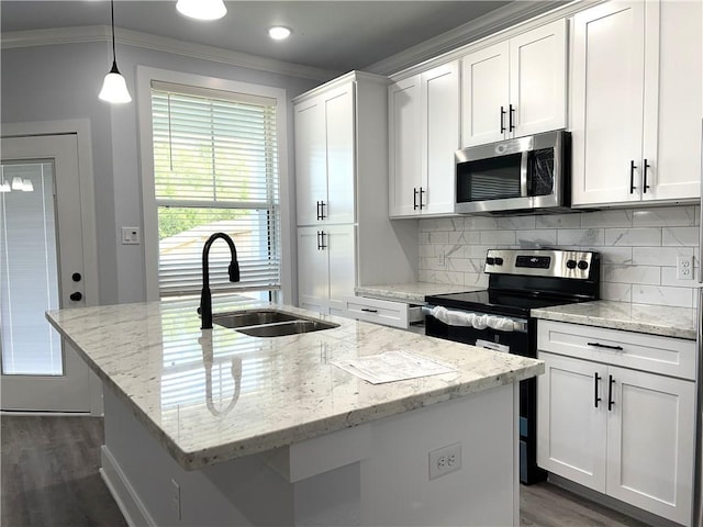 kitchen featuring appliances with stainless steel finishes, an island with sink, white cabinetry, and sink